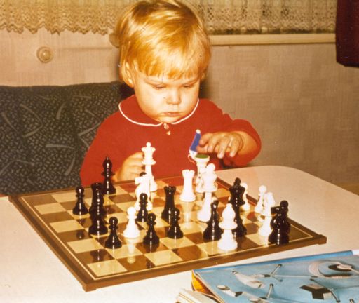 Sascha as a toddler looking concentrated on a chess board