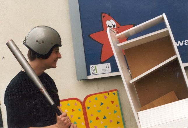 Sascha making contact with a shelf using a baseball bat